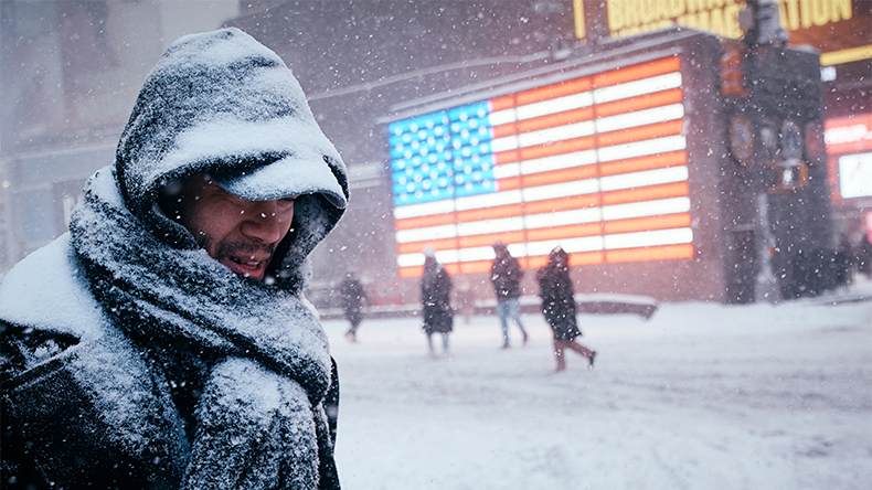 A man walks in Times Square during a snowstorm on January 25, 2026 in New York City in Winter Storm Fern
