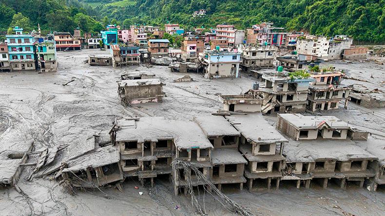 An aerial view shows houses lying deluged in sludge after flash floods at Devighat, Bidur Municipality in Nepal's Nuwakot district on August 27, 2026.