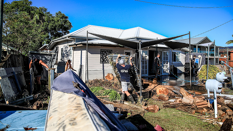  Residents clean a flood-damaged house at Glenthorne in Taree, Australia.