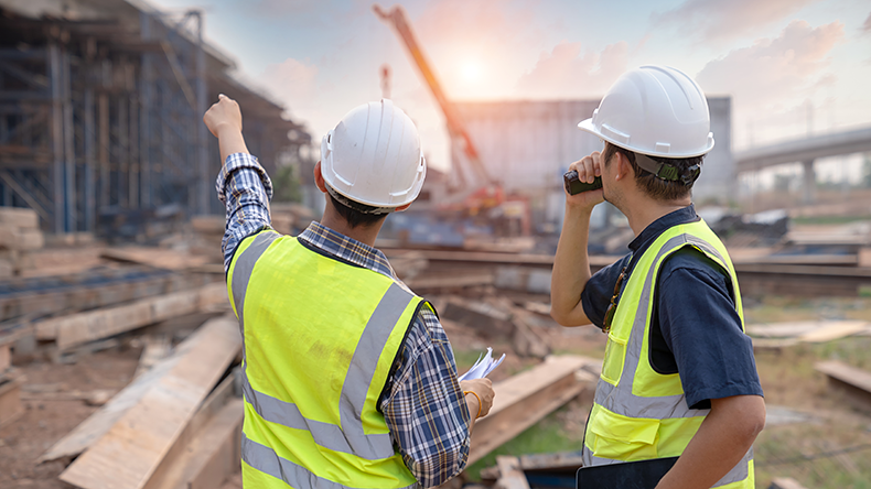 Construction supervision team and Civil engineers work at road construction site