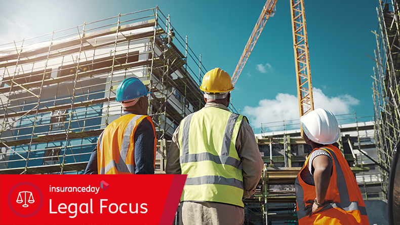 Creating thriving communities one building at a time. Shot of a group of builders assessing progress at a construction site.