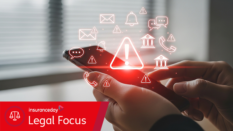 A person holds a smartphone displaying a glowing red warning icon with various notification and communication symbols