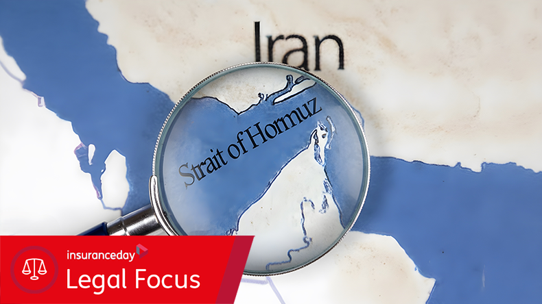 A magnifying glass focuses on the Strait of Hormuz, a vital waterway near Iran