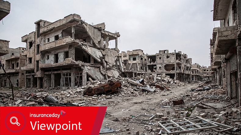 Extensive urban destruction, with collapsed buildings, rubble, and a burnt-out vehicle.