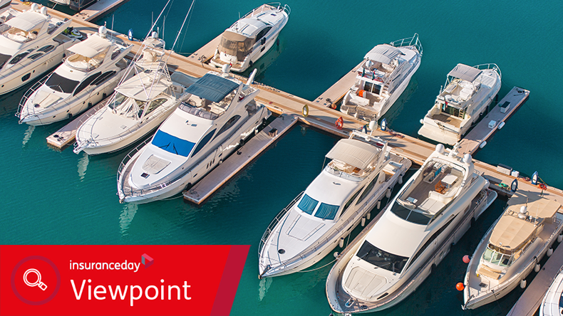 Aerial view of yacht club. White boats are in blue sea water.