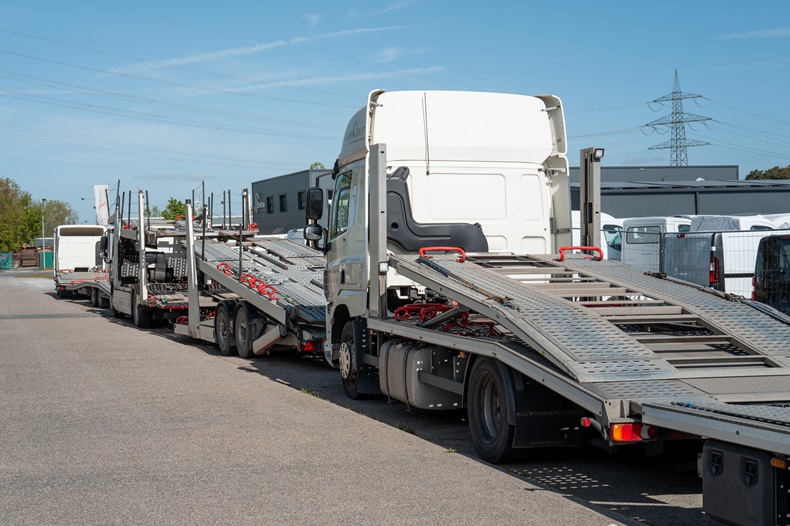 Automobile transport truck carrying empty platform for new cars