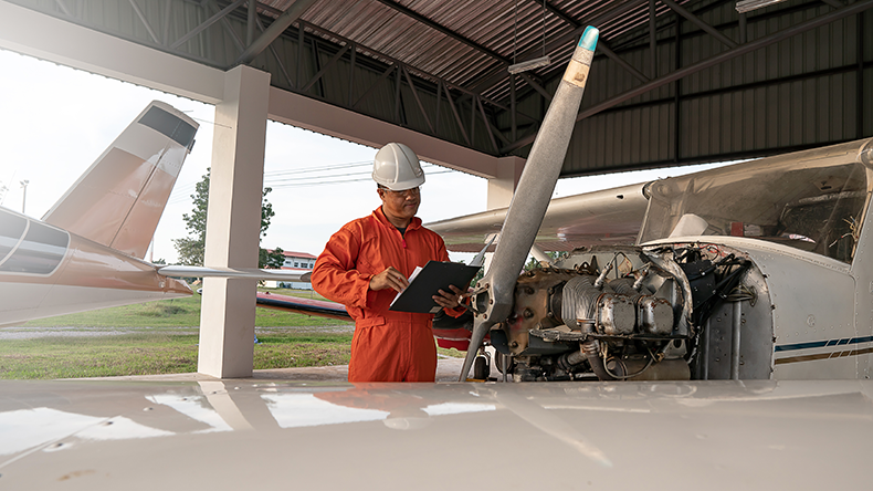 Asian male engineers were checking the availability of aircraft