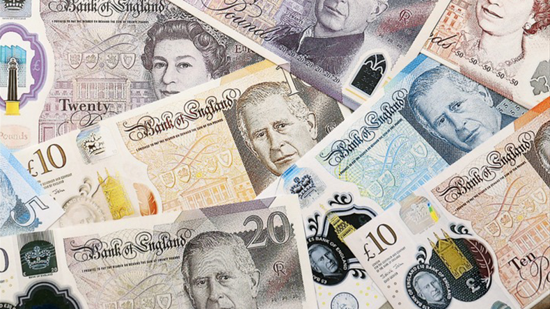 British pound money bills pile on table. United Kingdom banknotes of GBP currency close up. Concept of business, economy and investment in United .