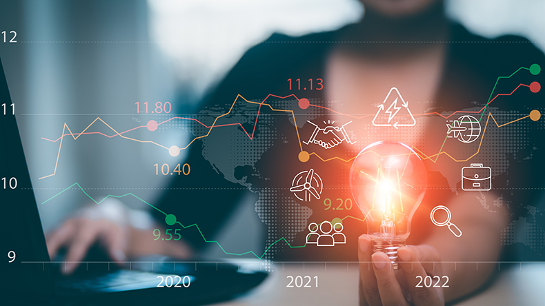 Businesswoman hand hold light bulb with tablet concept and Stock market or forex trading graph and candlestick chart suitable for financial investment money, currency exchange,Technology and Big Data