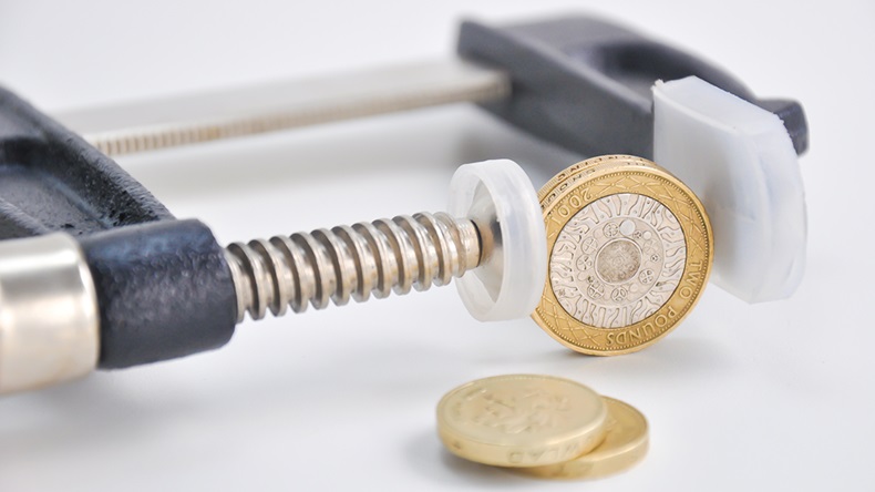 Coins in vice (Eviart/Shutterstock.com)