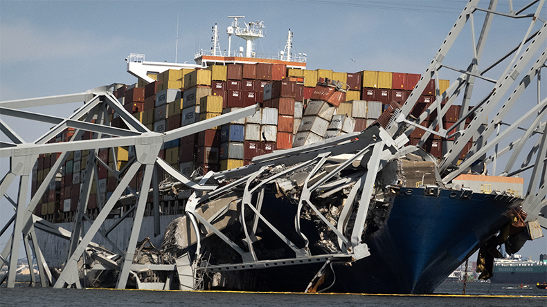Wreckage from the collapsed Francis Scott Key Bridge rests on the Dali cargoship as efforts begin to clear the debris