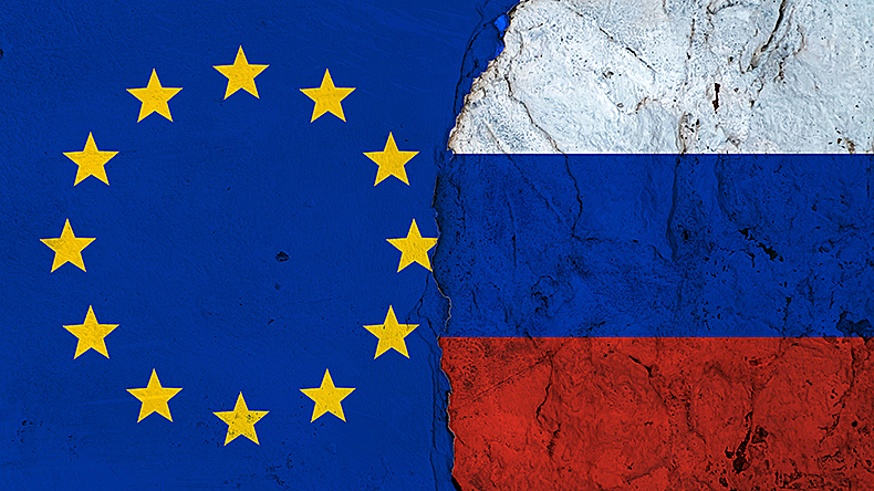 European Union and Russian country flags on broken wall background.