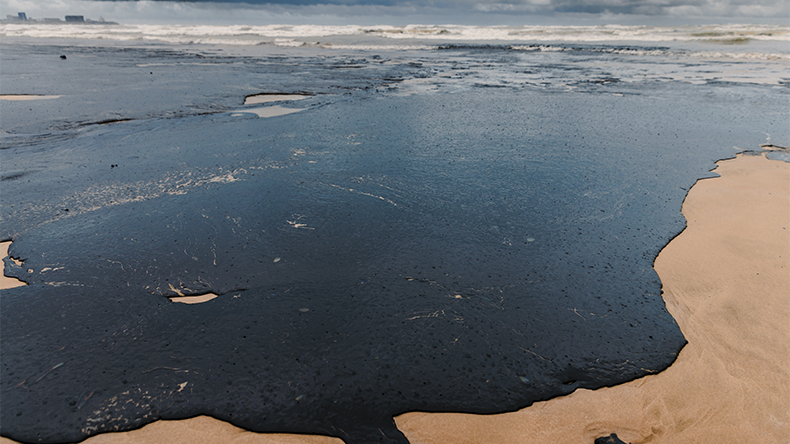 Oil in coastline after a tanker wreck. Fuel oil leak and polluted beach
