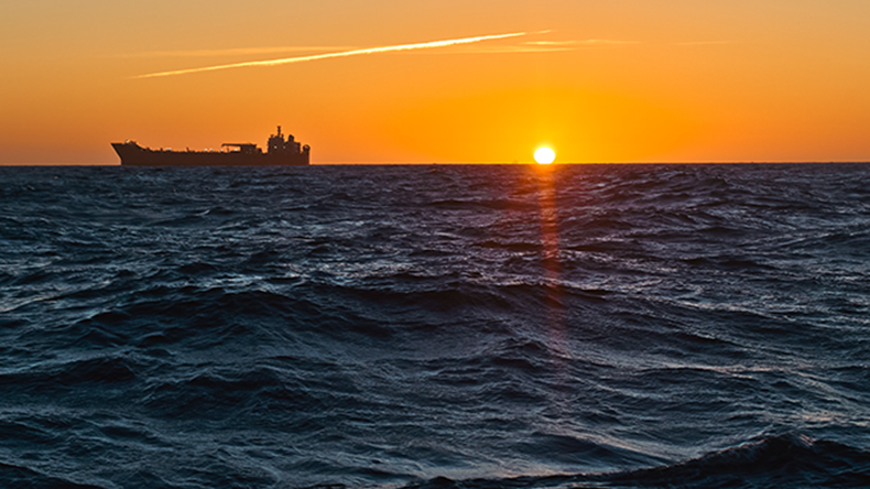 Tanker on horizon as the sun sets
