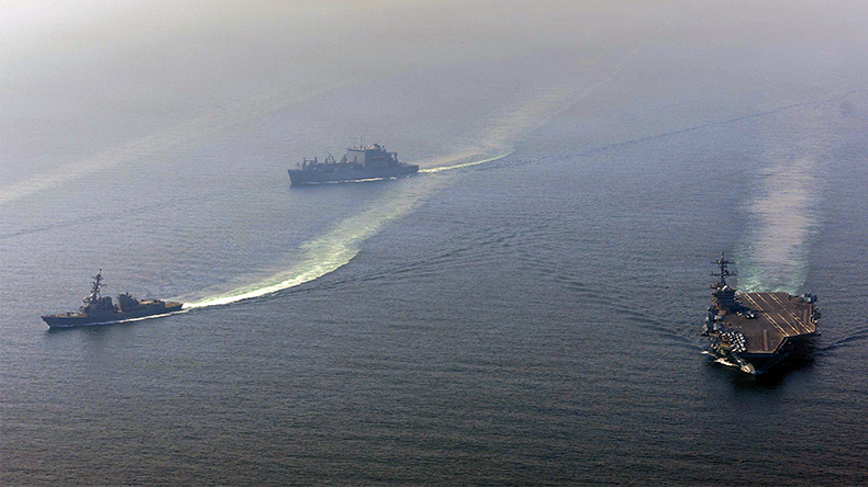 Nimitz-class aircraft carrier USS Abraham Lincoln (CVN 72) sails alongside Arleigh Burke-class guided-missile destroyer USS Frank E. Petersen Jr. (DDG 121) and Lewis and Clark-class dry cargo ship USNS Carl Brashear